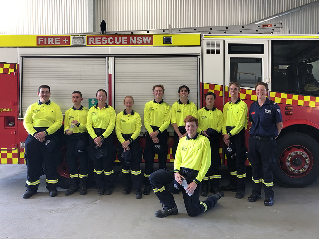 Photo of students standing in front of a fire truck